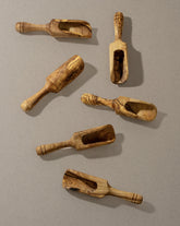 A collection of wooden scoops of various sizes, displayed against a neutral background.