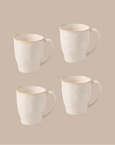 Four white ceramic mugs with a thin gold rim, arranged in a 2x2 grid on a solid beige background.