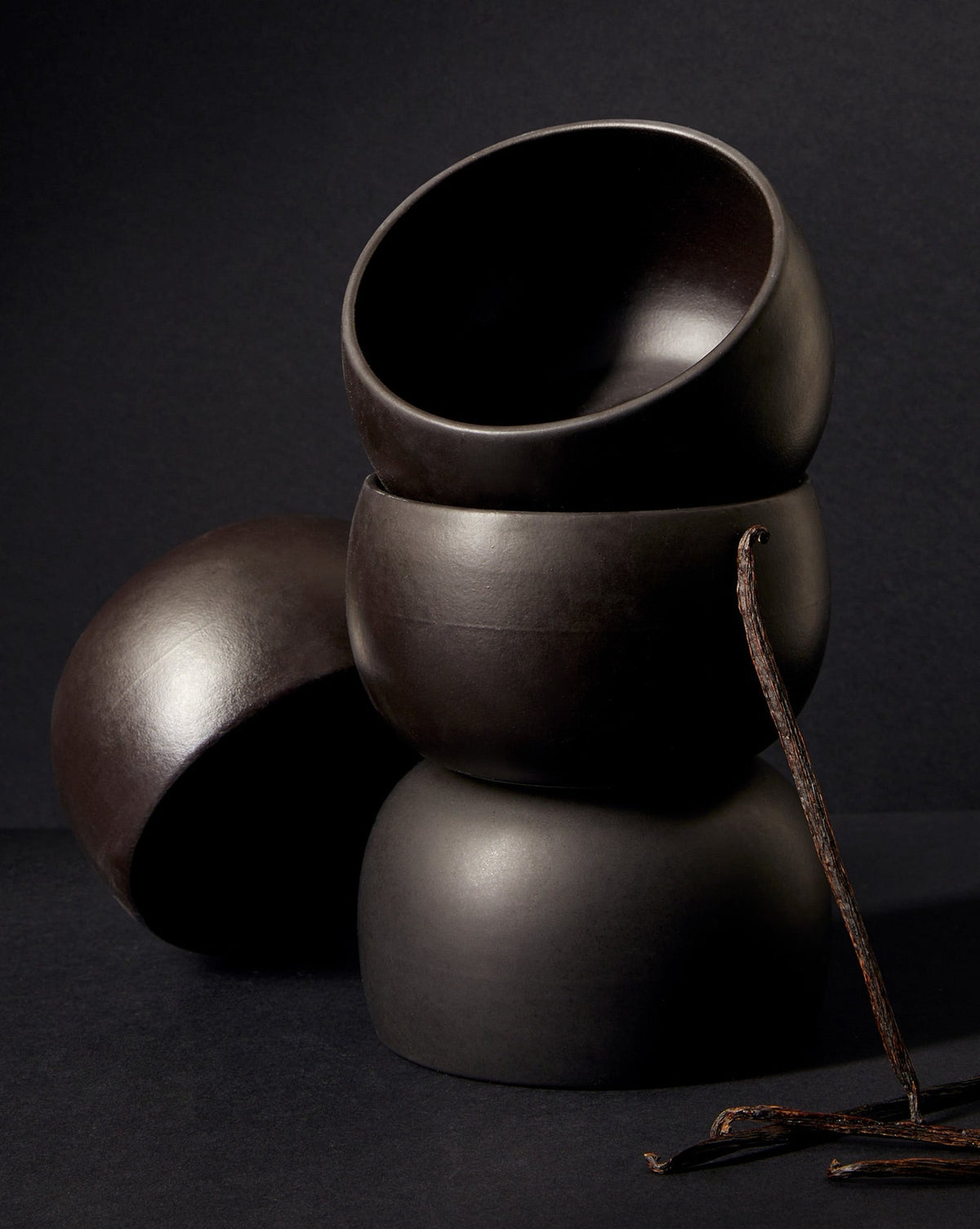 A stack of three white stoneware soup bowls of different sizes on a neutral background.